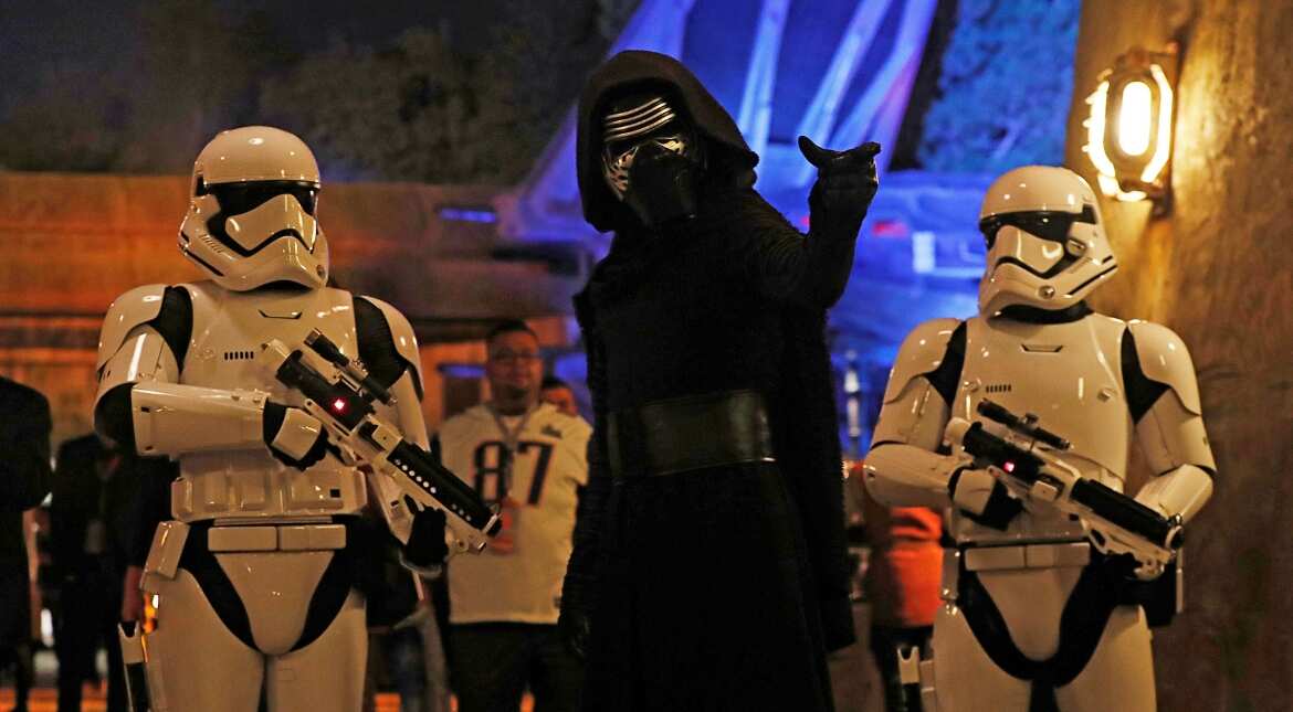 People dressed as stormtroopers and the character Kylo Ren