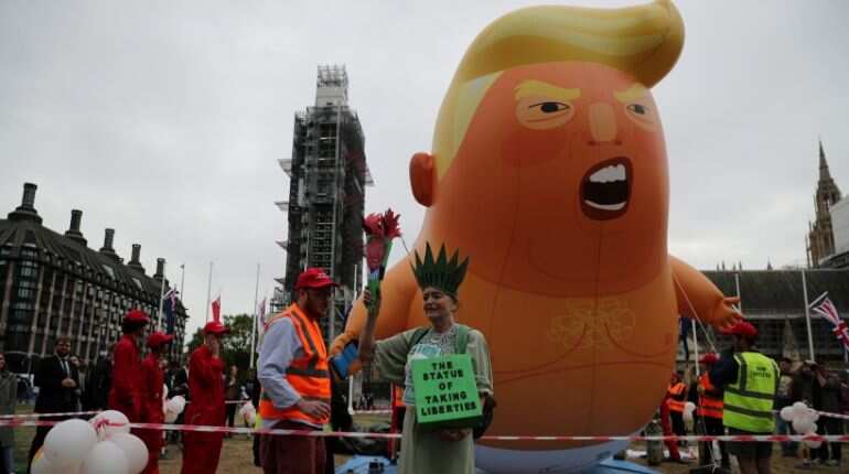 Donald Trump turns to Brexit and Huawei, protesters mock with a 'blimp' Donald Trump turns to Brexit and Huawei, protesters mock with a 'blimp'
