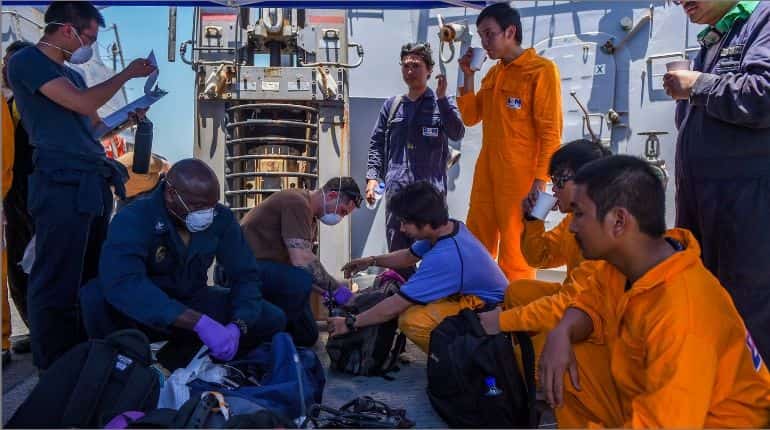 Crew members receiving medical attention
