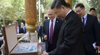Russia's Vladimir Putin gives China's Xi Jinping ice cream on his 66th birthday