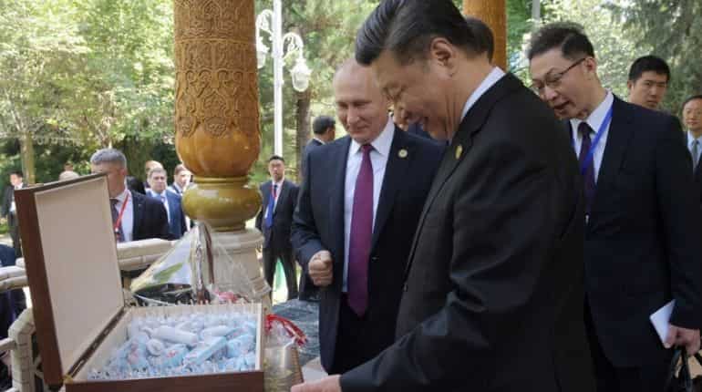 Russia's Vladimir Putin gives China's Xi Jinping ice cream on his 66th birthday