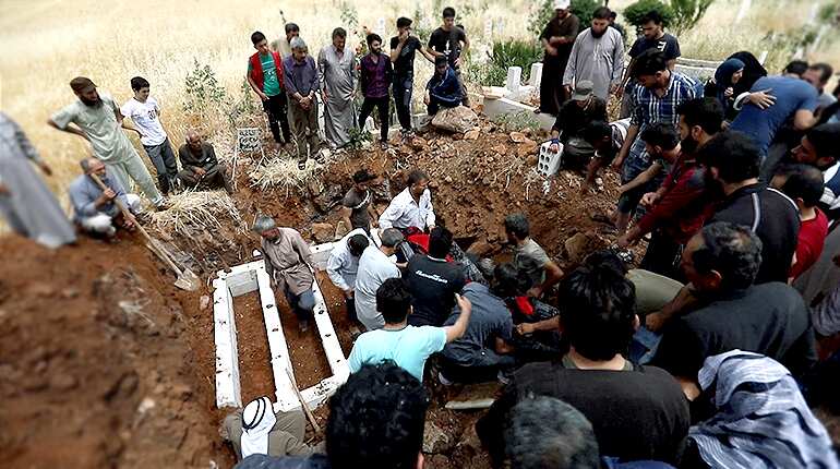 Hounded by war planes, Syrians dig Idlib graves in advance