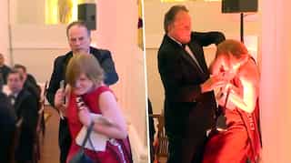 UK minister suspended after grabbing woman demonstrator by the neck