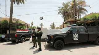 Baghdad protesters take down Bahrain flag over Trump peace conference