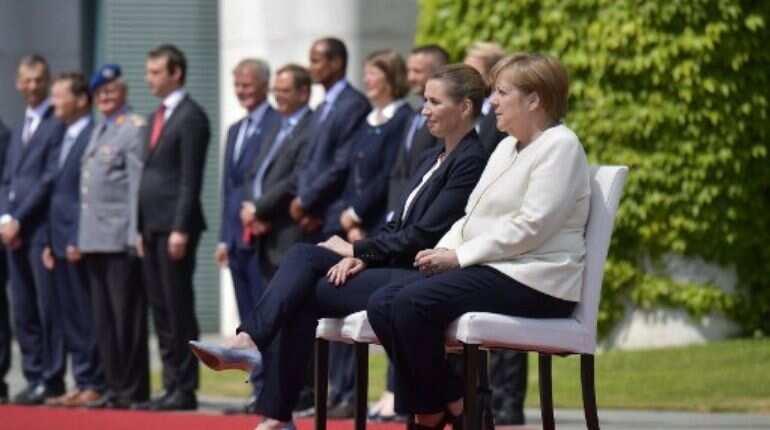 Merkel sits through anthems after shaking spells Merkel sits through anthems after shaking spells