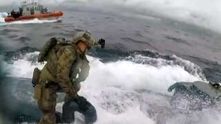 US Coast Guard officer jumps onto moving submarine suspected of carrying drugs