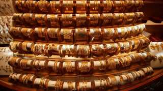 Gold edges up on weaker dollar, China data fuels growth concerns