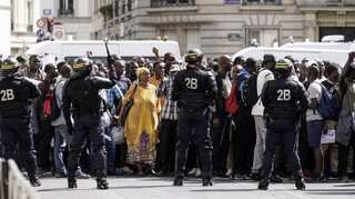 In Paris, hundreds of migrants occupy Paris landmark