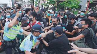 After scuffles, Hong Kong police warn protesters to refrain from violence, leave scene
