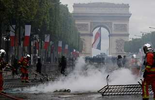 French police fire tear gas as protests follow Bastille Day parade