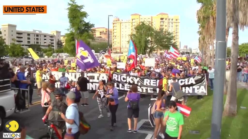 Waving flags and banging drums, Puerto Ricans demand that governor quit