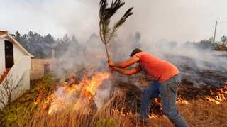 Villagers, firefighters battle huge blazes in central Portugal