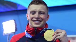 Britain's Adam Peaty completes world treble in men's 100m breaststroke