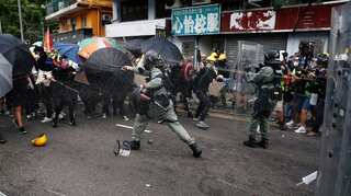 Clashes in Hong Kong after police charge protesters with rioting