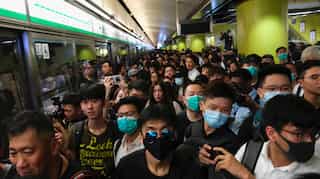 Protesters block train services in Hong Kong causing commuter chaos