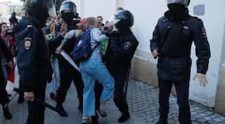 Russian police probe video of officer beating woman