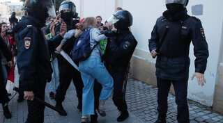 Russian police probe video of officer beating woman