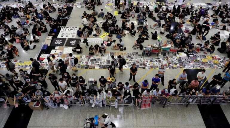 Hong Kong airport resumes flights after clashes, mass protests