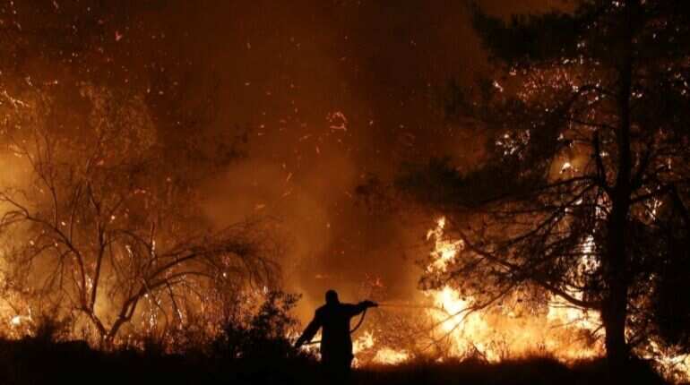 Fire rages on Greece's Evia, threat to people averted