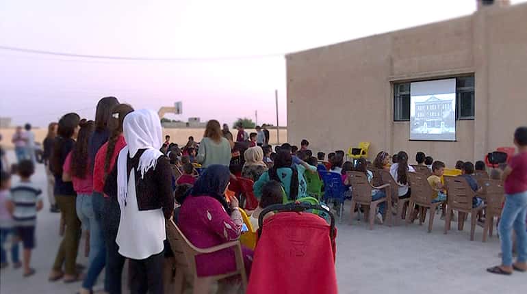 Mobile cinema brings movie magic to Syria Kurd children