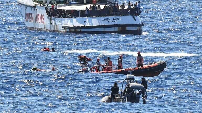 Tensions rise on migrant ship off Italy; 10 jump overboard