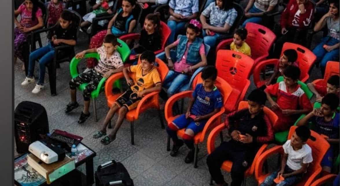Children enjoy a black-and-white film