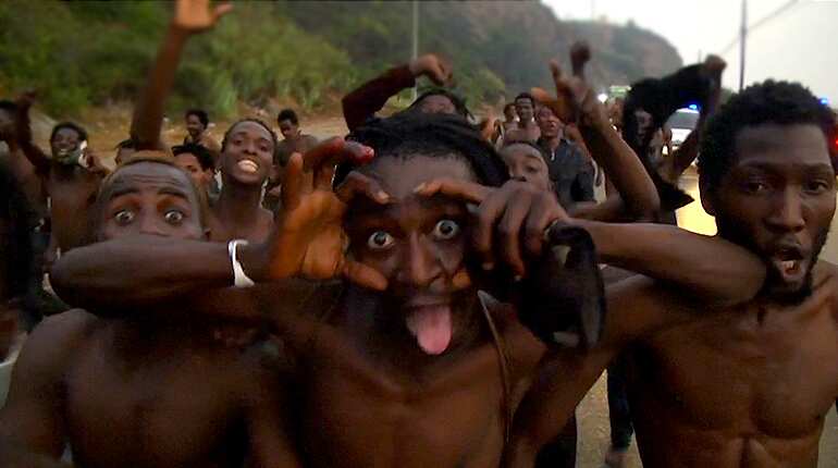 Over 150 migrants storm through Spain's enclave fence