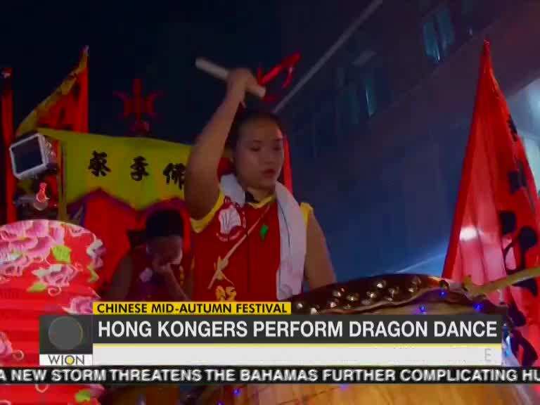 Hong Kongers perform dragon dance to celebrate Mid-Autumn Festival, calling for peace