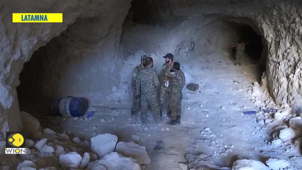Journalists see caves formerly used by rebels