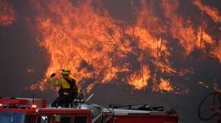 California firefighters tackle blazes in suburbs of Los Angeles