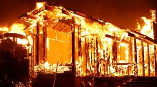 Firefighters struggle against massive, wind-whipped California wildfire