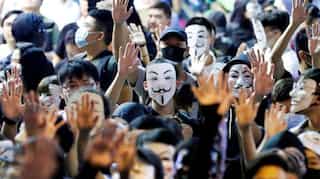 China to 'perfect' Hong Kong system as water cannon breaks up Guy Fawkes protest