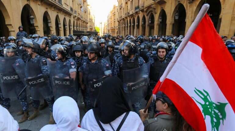 Protests force Lebanese parliament to postpone session; banks reopen