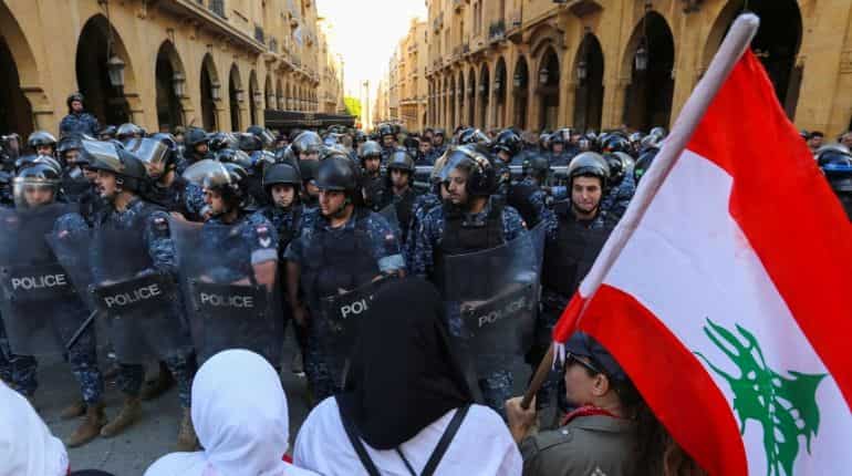 Protests force Lebanese parliament to postpone session; banks reopen
