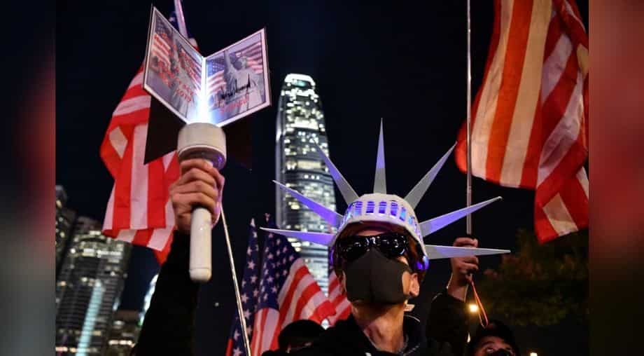 Draped in US flag, protestors stage 'Thanksgiving' rally after Trump signs Hong Kong Democracy act Draped in US flag, protestors stage 'Thanksgiving' rally after Trump signs Hong Kong Democracy act