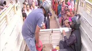 Cooperative employees in Patna don helmets for protection while selling onions