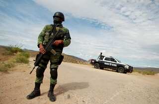 Shootouts in northern Mexican town kill 21, fueling debate on cartels
