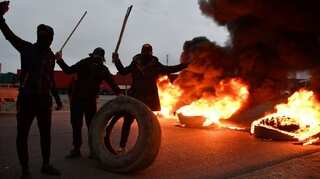 Iraq activist shot as protesters cut roads again