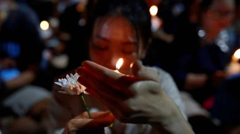Thousands light candles for victims of Thailand mass shooting