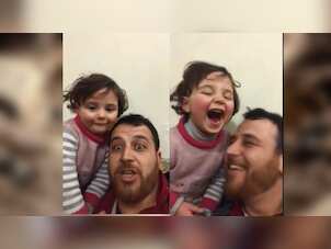 Watch: To cope with war trauma, Syrian father and daughter turn bombing sounds into rosy game
