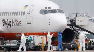 Fearing infection, residents protest coronavirus evacuees landing in Ukraine