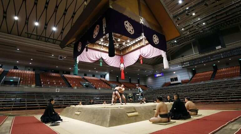 Japan's sumo wrestlers face off for spring tournament in front of empty seats