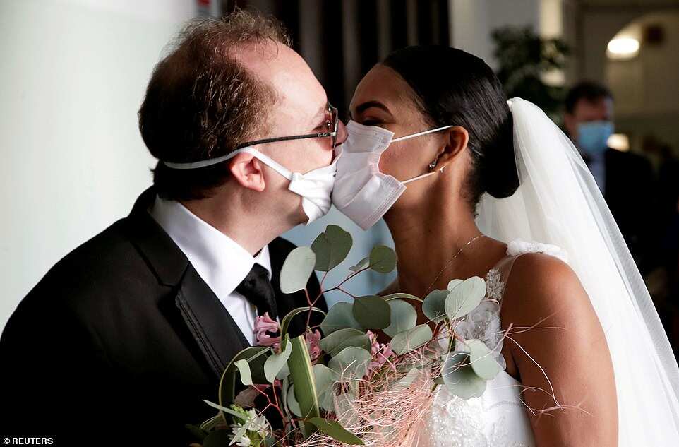 Love in the times of coronavirus: Newlyweds kiss in Italy through protective masks Love in the times of coronavirus: Newlyweds kiss in Italy through protective masks