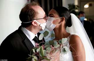 Love in the times of coronavirus: Newlyweds kiss in Italy through protective masks 