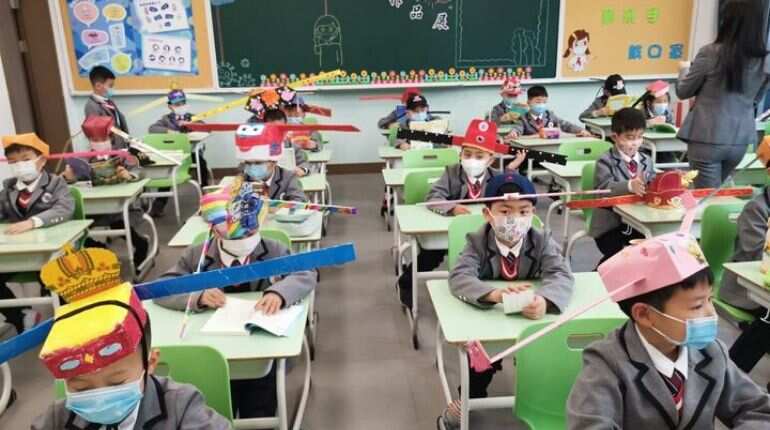 Chinese students maintaining one hat's distance after schools reopen