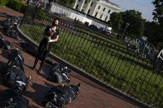 Protesters stage mock funeral procession outside White House