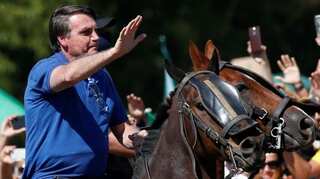 From helicopter to horseback, Brazilian President Bolsonaro breaks COVID 19 protocol to join protesters