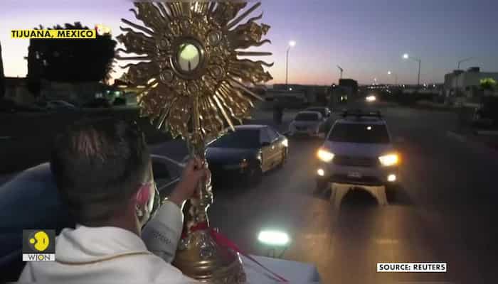 Tijuana priest rides around city blessing people from the back of a pickup truck