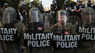 Four police officers shot in violent protests after Trump vows to bring in US military