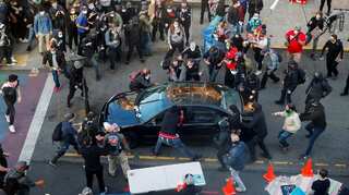 Man rams car into a horde of protesters in Seattle, shoots bystander